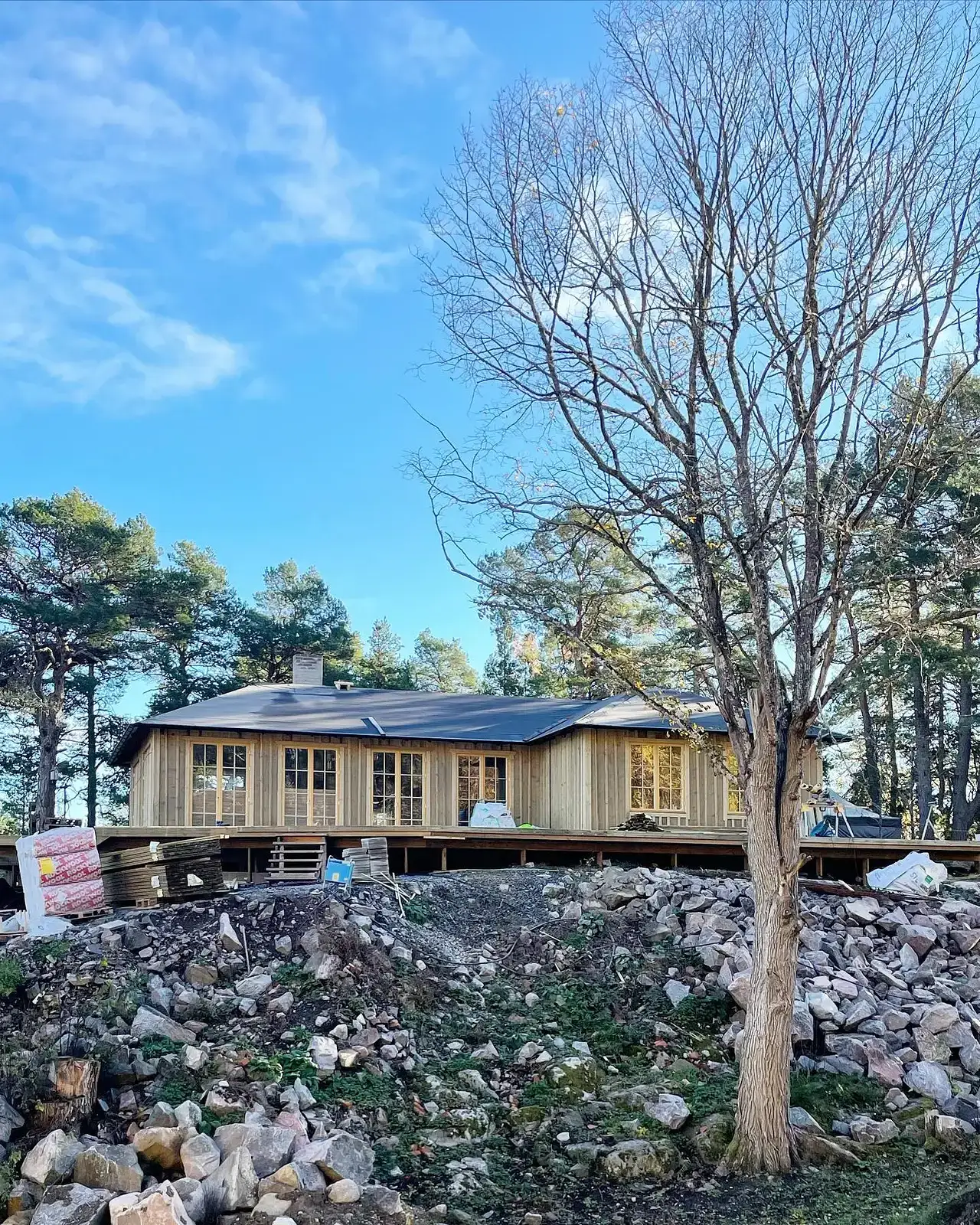 Trätrappa med spjälräcke och horisontella ribbor under trappan.